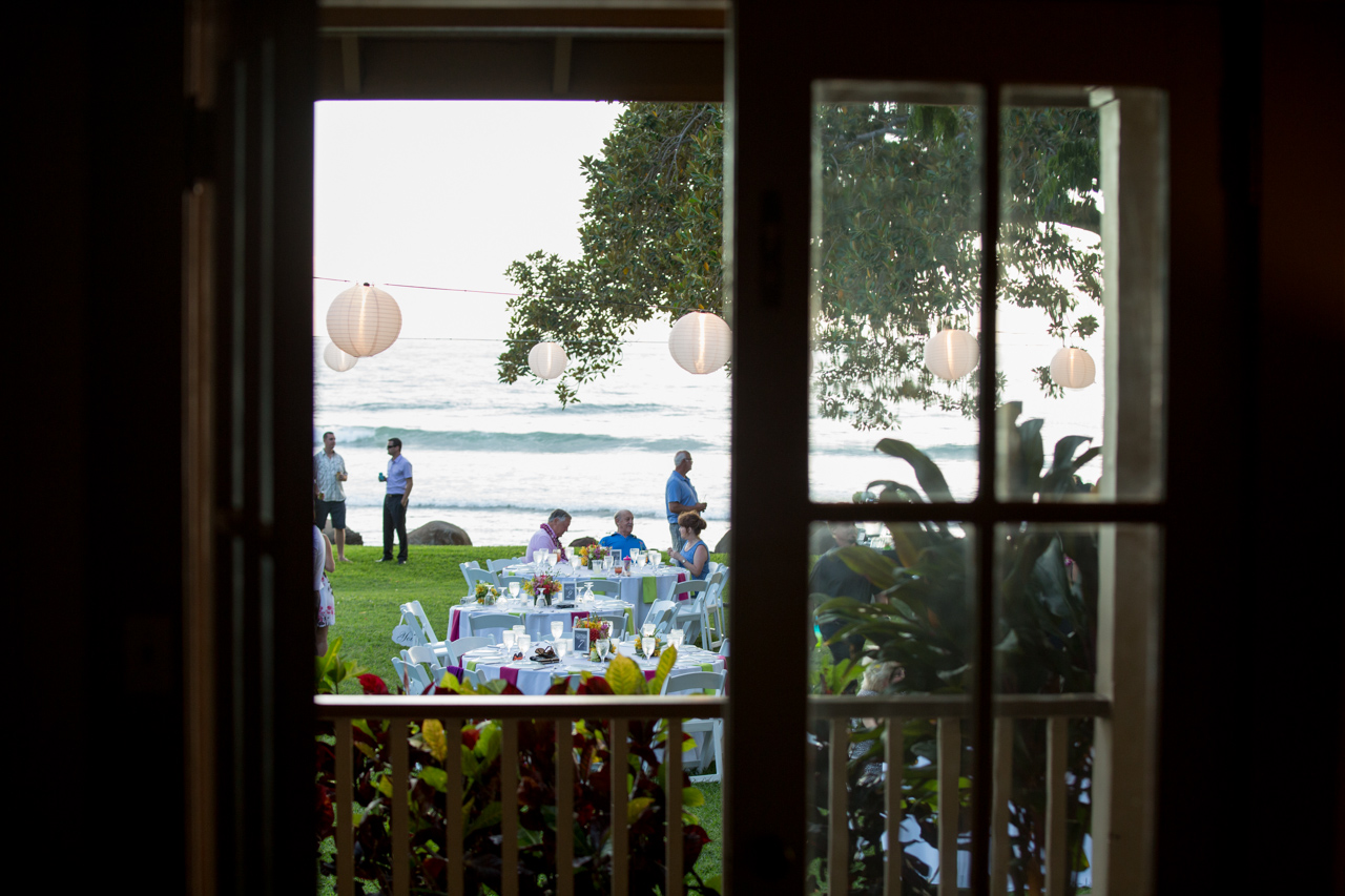 a picture looking out of a historic house at Olowalu to a wedding reception