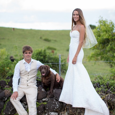 a wedding couple and their dog pose for a photograph
