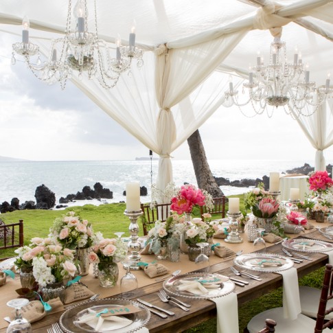 a beautiful wedding table set up at the white orchid beach house