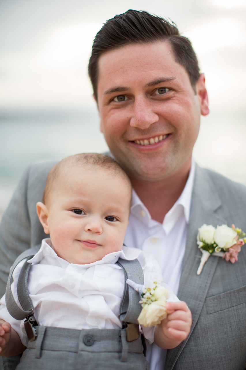 A groom and his infant son dressed to the nines.